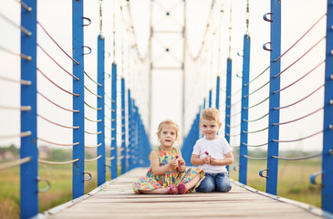 laughing small kids playing on the bridge