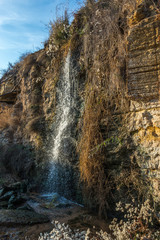 Fototapeta na wymiar Stream and a small waterfall near the sea