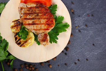 grilled steak with parsley on stone background