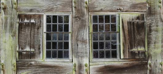 Old dark windows, a close look. Architecture of Europe. Middle ages.