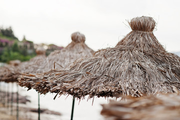Bamboo and reed straw beach umbrellas.