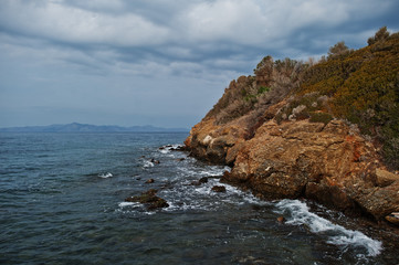 Fototapeta na wymiar Sea wave breaks on beach rocks landscape. Sea waves crash and splash on rocks at Bodrum, Turkey.