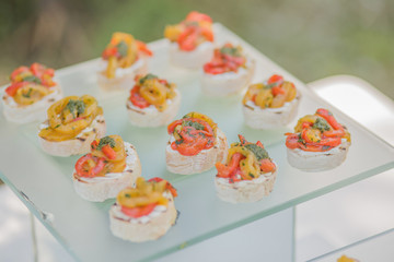 Snacks from fish and cheese and tomatoes for a birthday or wedding.
