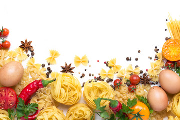 Different types of italian pasta, nests, spaghetti, spices, Red hot chilli pepper, chicken eggs, tomatoes, cherry, light white stone background. Flat lay, top view