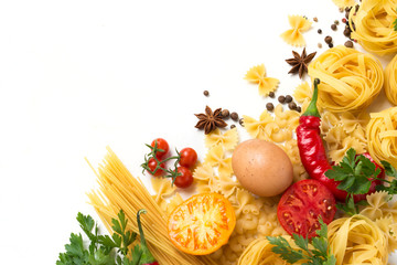 Italian pasta of different kinds with spices, red hot pepper, chicken eggs, yellow and red tomatoes on a white stone background. Concept cooking Italian pasta and sauce. Flat lay, top view