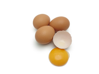 Whole eggs with cracked egg showing yolk isolated on white background