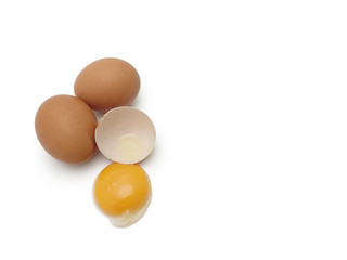 Whole eggs with cracked egg showing yolk isolated on white background