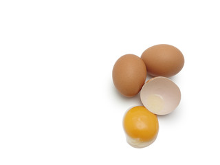 Whole eggs with cracked egg showing yolk isolated on white background
