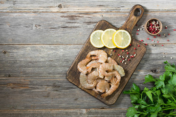 Tiger prawns on a wooden Board. Gray background. Seafood