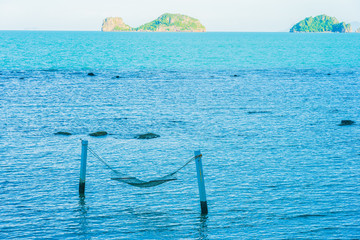Empty hammock around beautiful beach sea ocean for relax in holiday vacation