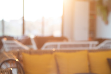 Abstract blurred livingroom decoration interior for background with warm light from sunrise vintage tone
