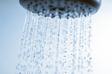 Obraz na płótnie Canvas Falling water drops and shower head.