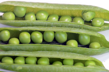 Look into open pea pods with peas.