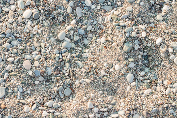 Beach stone pebbles. The texture of small stones and sand. Can be used as a texture, background or wallpaper