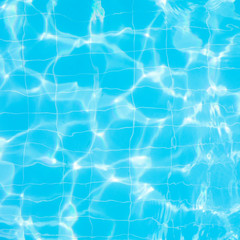 Water vibrations in the swimming pool with sun reflection. blue swimming pool surface, water background in swimming pool. Flat lay, top view