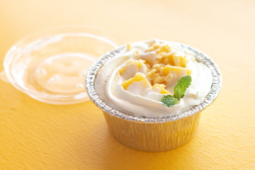 Summer fruit dessert is Mango cheesecake on yellow table background