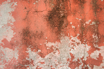 Old stone wall with plaster, worn paint and mold. Can be used as a texture, background or wallpaper