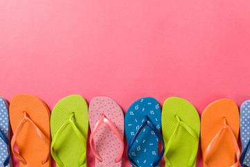 a lot of flip flop colored sandals, summer vacation on colored background, copy space top view