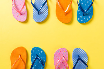 a lot of flip flop colored sandals, summer vacation on colored background, copy space top view