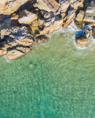 Top beautiful view of a beach at sunrise with beautiful waves lines, shallow turquoise water