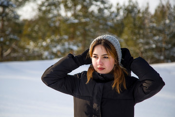 portrait of a beautiful girl in the winter park