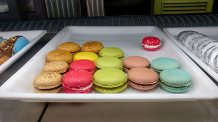 Different colored French macaroon displayed on a tray in a confectionery bakery shop for sale in a mall in New Delhi, India