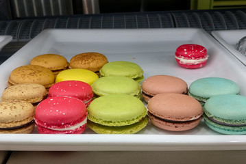 Different colored French macaroon displayed on a tray in a confectionery bakery shop for sale in a mall in New Delhi, India