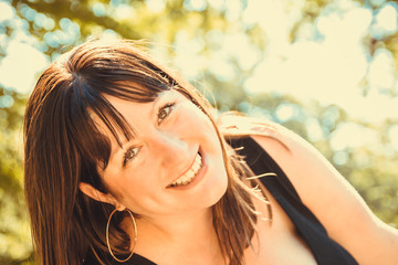 Portrait of a beautiful woman smiling in the sunshine.