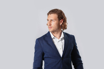Stylish young man in formal clothes on white background