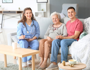 Caregiver visiting senior woman at home