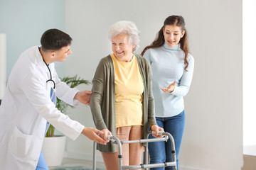 Doctor visiting senior woman at home