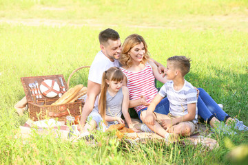 Fototapeta premium Happy family on summer picnic in park