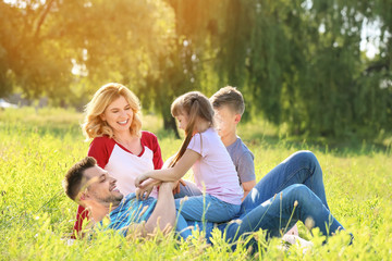 Fototapeta premium Happy family resting in park