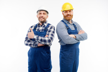 Two engineers smiling at camera on white background