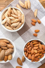Bowls with almonds on table
