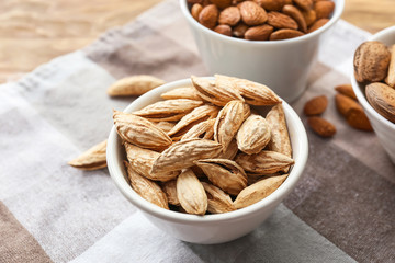 Bowl with almonds on table