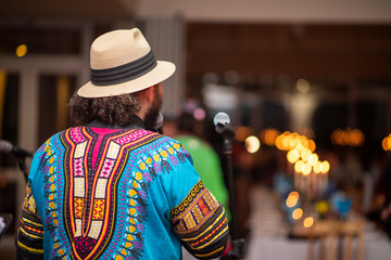 Fototapeta premium Musician performing at private event shot from behind