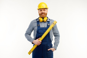 Engineer stands with a leveling ruler in his hands on a white background