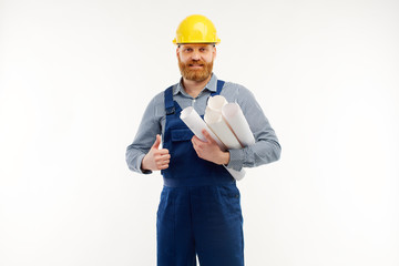 Engineer with drafts in hands is smiling at camera on white background