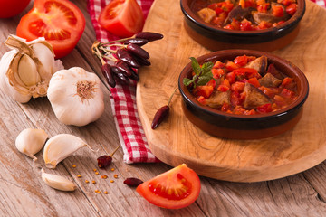 Marinated pork loin in tomato sauce.