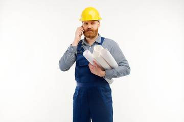 Engineer talking on the phone with a drawing in his hand on a white background