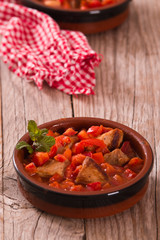 Marinated pork loin in tomato sauce.