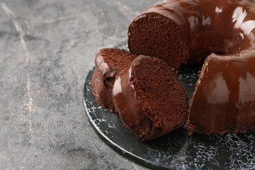 Plate with tasty chocolate cake on grey table
