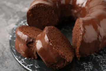 Plate with tasty chocolate cake on grey table, closeup