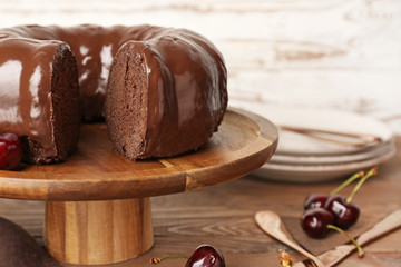 Dessert stand with tasty chocolate cake on table