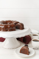 Dessert stand with tasty chocolate cake on table