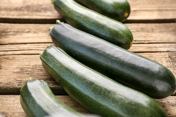 Fresh zucchini squashes on wooden background