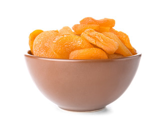 Bowl with dried apricots on white background