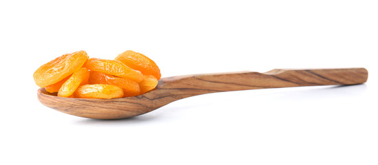 Spoon with dried apricots on white background