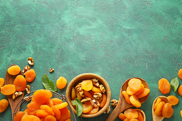 Composition with dried apricots on color background